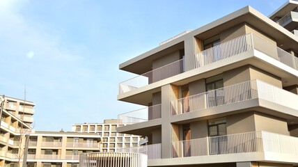 Apartment residential house and home facade architecture and outdoor facilities. Blue sky on the background. Sunlight