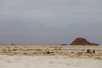 ethiopian salt lake landscape with brown mountain in it