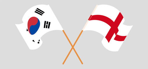 Crossed and waving flags of England and South Korea