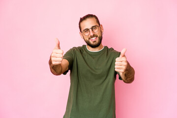 Young man with long hair look smiling and raising thumb up