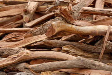 many pieces of wood stacked in a pile to form an interesting pattern