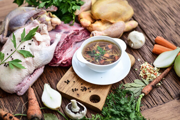 Slow-boiled broth based on several types of meat and aromatic vegetables. - obrazy, fototapety, plakaty