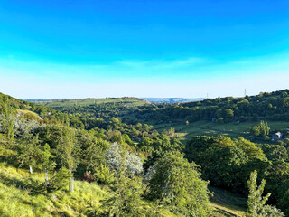 Fototapeta na wymiar Landscape, Shibden Valley, on a late summers day, with old trees, fields, and a blue sky in, Halifax, Yorkshire, UK