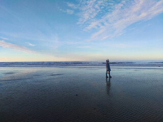 Girl on the background of the sea and blue sky coast of the English Channel in France in the city of Deauville. Travel across France. Woman traveler
