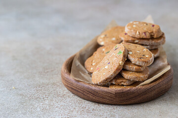 Danish spicy butter cookies with candied fruits, light concrete background.