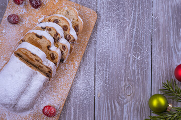 Christmas marzipan stollen cake with icing sugar, marzipan and raisins.