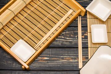 Sushi accessories on a brown wooden background

