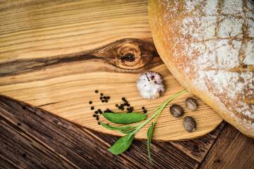 
Herbs and spices on an ash serving board. - obrazy, fototapety, plakaty