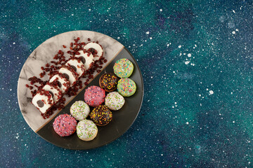 Colorful set of sweet small doughnuts on a plate
