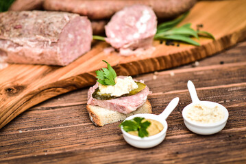 Traditional cold cuts served on wooden boards. - obrazy, fototapety, plakaty
