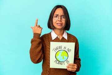 Young hispanic mixed race woman holding a planet save placard showing a disappointment gesture with forefinger.