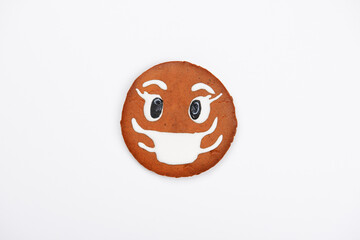 The hand-made eatable gingerbread Earth with face mask concept on white background