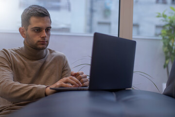 man working at home with laptop