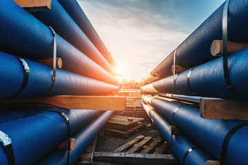 Stack of Cast iron pipes for sewerage ready for transportation and logistic. - obrazy, fototapety, plakaty