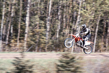 Naklejka premium Wheelie dirt bike rider one wheel high speed motorbike