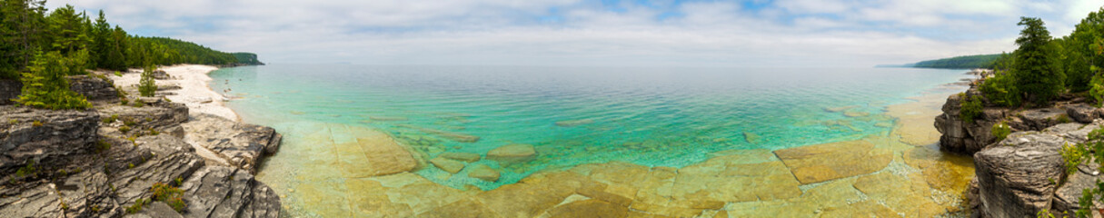 Panorama of the crystal clear blue and turquoise waters on a beach at Bruce Peninsula National...