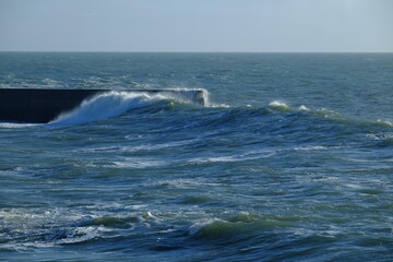 A big wave breaking in the small harbour of Batz sur mer. (West of France, december 2020)