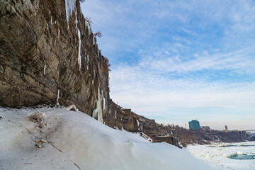 Fototapeta na wymiar Ontario's Niagara Falls cliff edge covered in dense icicles and snowfall