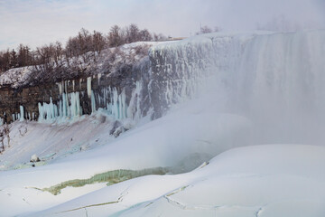 Niagara Falls covered in snow, icicles, and mist