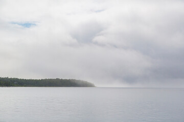Naklejka na ściany i meble A view of Tobermory covered in a morning fog over the Georgian Bay of Canada.
