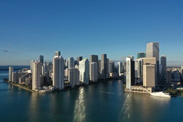 Miami, Florida - December 27, 2020 - Aerial view of City of Miami and entrance to Miami River on sunny winter morning.