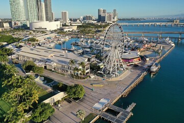 Fototapeta premium Miami, Florida - December 27, 2020 - Aerial view of Bayside Marketplace, City of Miami Marina and Miami skyline on sunny winter morning.