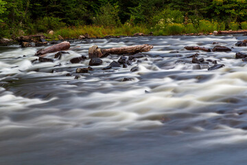 Long exposure photo of rushing water flowing in a river in Algonquin Park, Ontario, Canada
