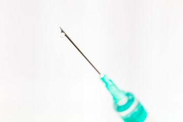 Needle with drop isolated on white background, macro.