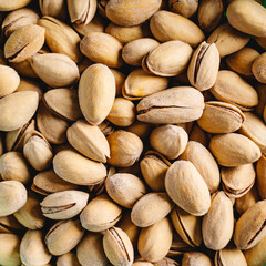 Full frame close up on top view on fresh salted roasted pistachios snack nuts background