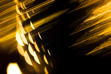 Abstract illuminating golden backdround with linear and spherical shapes. Isolated black background...