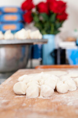 Fototapeta na wymiar Dumplings with white flour dough and back bread