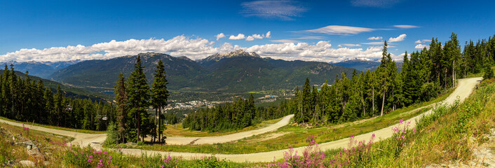 Panorama of the Whistler village and mountains in British Columbia, Canada in the summer with blue cloudy sky