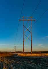 power lines and pylons at dusk.