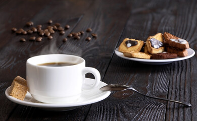 A cup of coffee on a wooden background. Morning hot coffee on a wooden table. A white coffee cup. Steam.Espresso