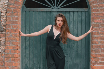 beautiful young woman whit a black jumpsuit in vintage place