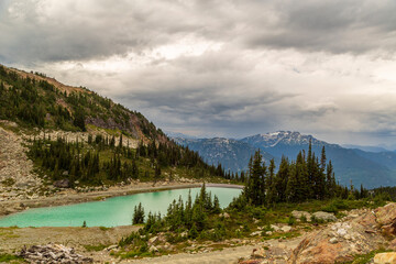 Magnificent view of the mountains peaks and turquoise lake clouds in Whistler British Columbia, Canada
