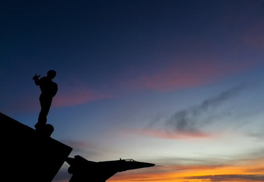 sunset and silhouettes of monuments,Rio Gallegos, Argentina,unrecognizable monuments are man called the monument to the fallen pilots in Malvina,plane called the monument to the pilot of the air force - Powered by Adobe