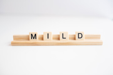 the word mild written in scrabble titles against a white background