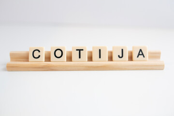 the word cotija cheese written in scrabble titles against a white background