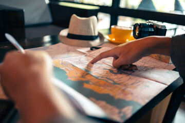 Close-up Tourist planning vacation with map and other travel accessories on the table. Travel, holiday, vocation concept. - obrazy, fototapety, plakaty
