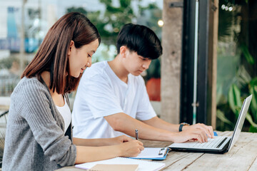 High school or college students  group catching up workbook and learning tutoring on desk and reading, doing homework, lesson practice preparing exam.