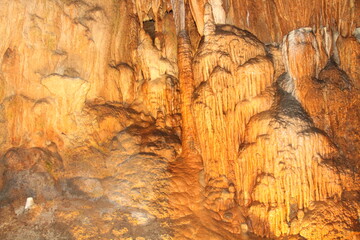 Fototapeta na wymiar Stalactites hold tight to the ceiling, and Stalagmites on floor. Fantastic Cavern, Springfield, Missouri. 