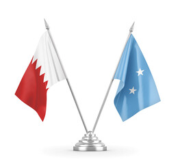 Micronesia and Bahrain table flags isolated on white 3D rendering 