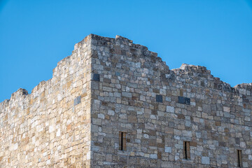 Ruins of the fortress wall against the blue sky