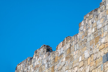Ruins of the fortress wall against the blue sky