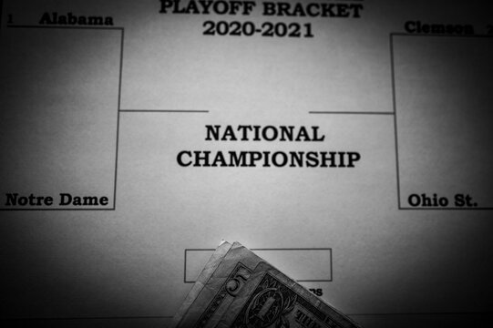 Tiffin, Iowa, USA: 12-2020:  Printed Out NCAA Football Championship Bracket With Loose Money On Top