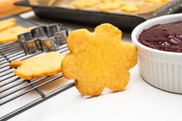 Sugar cookies in cute flower shapes close up. Shortbread cookies filled with raspberry jam recipe