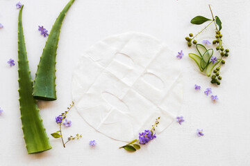 natural aroma sheet mask for skin face from herbal aloe vera essence face mask arrangement flat lay sltyle on background white wooden