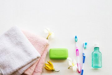 herbal soap with terry cloth health care for body skin care cleaning to a bath and toothbrush ,mouthwash for health care oral cavity with flower frangipani on background white