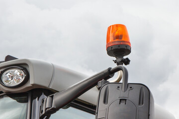 Orange signal lamp on forklift, excavator or other industrial machine. Safety during work